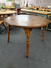 Load image into Gallery viewer, This round wooden dining table offers reliable everyday functionality for four place settings. Structurally sound with a solid frame, it bears signs of use—surface marks that tell its story without compromising usability. The legs detach for convenient relocation and storage. The extending leaf is missing. A genuine, no-nonsense choice for those who value substance over perfection.

Delivery Available

Overall Dimensions

107cm diameter x 76cm high

