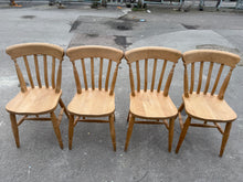 Load image into Gallery viewer, A charming set of four solid pine dining chairs with authentic character. Each chair is structurally sound and ready for everyday use. The natural patina and minor marks reflect their history, while one features a subtle repair that doesn't compromise durability. Ideal for creating a warm, rustic country aesthetic in your dining space. A practical choice for those who appreciate vintage appeal and solid craftsmanship.

Delivery Available

Overall Dimensions

approx : 40cm wide x 41cm deep x 83cm high

