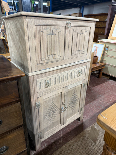 This beautiful oak drinks cabinet has been carefully stripped back to reveal its natural grain, giving it a charming, rustic look. While it may benefit from a protective coat of wax, its raw finish makes it a versatile piece that can easily fit into any décor style. Designed for practical use, it features two spacious cupboards and a long dovetail jointed drawer, offering plenty of room to neatly store your bottles, glasses, and bar accessories.

Overall Dimensions

74.5cm wide x 43cm deep x 124cm high

DEL