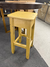 Load image into Gallery viewer, A charming wooden stool with a gold finish applied by its former owners. While the paint shows character, it could be refreshed with a new coat if desired. Perfect for displaying potted plants or serving as an unconventional accent table in any room.

Delivery Available

Overall Dimensions

31cm wide x 31cm deep x 69cm high

