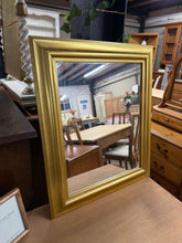 Load image into Gallery viewer, This charming small mirror features a sturdy gold frame and is in great overall shape. It shows some minor signs of use but nothing significant. A convenient string on the back makes hanging simple and hassle-free.

Delivery Available

Overall Dimensions

53cm wide x 63.5cm high

Split the cost over 3 months with KLARNA when you spend £50 or more          

All our items are second hand so may have a few marks,knocks ,chips etc that aren&#39;t clearly seen in the photos.

Please note that not all items are avai
