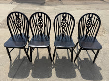 Load image into Gallery viewer, A charming set of four oak wheelback chairs, each structurally sound and in good overall condition. These vintage pieces bear the gentle patina of age with minor surface marks that add character rather than detract from their appeal. Ideal for period properties, traditional dining rooms, or anyone seeking authentic, timeless seating with genuine heritage appeal.

Delivery Available

Overall Dimensions

approx : 37cm wide x 44cm deep x 91cm high

