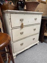 Load image into Gallery viewer, This charming solid wooden chest of drawers features a beautiful white shabby chic finish that brings character and warmth to any room. The distressed paintwork creates an authentic, lived-in aesthetic perfect for vintage and farmhouse interiors. Built with three spacious dovetail-jointed drawers, it offers reliable storage with excellent structural integrity. A versatile piece that combines timeless style with practical functionality.

Delivery Available

Overall Dimensions

84cm wide x 48cm deep x 87cm hi
