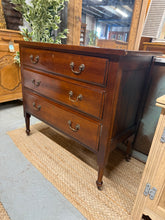 Load image into Gallery viewer, This Edwardian mahogany chest combines period charm with practical storage. Built to last, the piece maintains structural integrity with only light cosmetic signs of use. Three generously proportioned drawers with dovetail joints provide substantial storage space. The solid construction and timeless design make it equally suited to traditional interiors or creative up-cycling projects, such as converting it into a custom vanity or dressing table.

Delivery Available

Overall Dimensions

91.5cm wide x 45cm d
