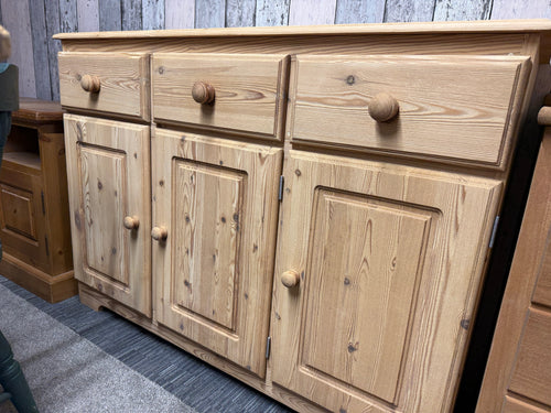 This beautiful solid pine sideboard has been fully restored to its natural finish, making it perfect for adding a protective wax coat if you wish. It features three small drawers above a spacious double and single cupboard, offering plenty of handy storage.

Overall Dimensions

122cm wide x 40cm deep x 88cm high

DELIVERY AVAILABLE      

For our other items see our website https://fossewayfurniture.co.uk

collection from our shop at cv36, our collection zone at bs36 or otherwise delivery is available
