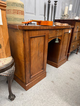 Load image into Gallery viewer, A handsome mahogany desk from the mid-19th century, offering authentic period character with practical storage. The piece remains structurally sound and is in good overall condition, with the natural patina and minor marks that reflect its age and use. Features include two cupboards—one fitted with two drawers and the other with a shelf—plus a central drawer with its original key. An elegant addition to any study or period home.

Delivery Available

Overall Dimensions

119cm wide x 50cm deep x 78cm high

