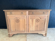 Load image into Gallery viewer, This striking satinwood sideboard has been carefully stripped to reveal its natural grain and warm patina. While structurally sound and in excellent overall condition, the bare wood finish may benefit from a protective coat of wax to enhance durability and lustre. Thoughtfully designed with practical storage, it features two dovetail-jointed drawers above a spacious double cupboard—ideal for displaying tableware, linens, or decorative pieces. Minor surface marks add character and authenticity to this vintag
