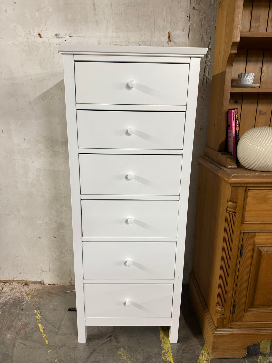 With a narrow frame that makes it well-suited in smaller bedrooms, this tallboy chest is made from high-quality timbers and available in a choice of crisp, painted finishes. Six drawers provide plenty of storage space for your essentials. Unfortunatley there is damage to the top corner and a small crack to the leg but this does not affect its use. This RRP's at £249.

Overall Dimensions

55cm wide x 44cm deep x 137cm high

DELIVERY AVAILABLE      

For our other items see our website https://fossewayfurnitu