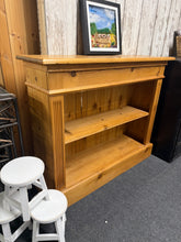Load image into Gallery viewer, A charming pine bookcase with solid construction and timeless appeal. Features a single shelf offering practical storage for books, decorative items, or collectibles. This pre-loved piece shows gentle signs of age and use, adding to its authentic character. Ideal for adding warmth and functionality to any room.

Delivery Available

Overall Dimensions

92cm wide x 27.5cm deep x 77cm high

