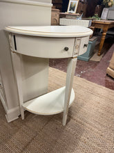 Load image into Gallery viewer, A charming white demi lune hall table that's built to last. While it shows minor cosmetic marks consistent with age, the structure remains solid and reliable. Two practical drawers and a lower shelf provide ample storage for hallway essentials, making it both functional and stylish for your entryway.

Delivery Available

Overall Dimensions

60cm wide x 30cm deep x 77cm high


