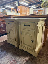 Load image into Gallery viewer, A charming pair of cream / white French-style bedside tables, each featuring a dovetail-jointed drawer and cupboard storage. Structurally sound and in good overall condition, with minor cosmetic wear to the skirts that reflects their used character. Perfect for adding classic elegance to a bedroom whilst offering practical storage solutions.

Delivery Available

Overall Dimensions

46cm wide x 38cm deep x 72cm high

