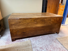 Load image into Gallery viewer, A sturdy hardwood trunk with authentic character. Structurally sound and in good overall condition, this vintage piece shows honest wear with surface marks that add to its charm. A light polish will restore much of its original lustre. Features spacious storage drawers at each end, making it both decorative and practical for any room.

Delivery Available

Overall Dimensions

110cm wide x 59cm deep x 45cm high

