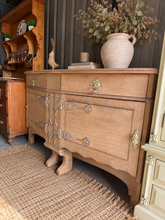Load image into Gallery viewer, A beautiful stripped oak sideboard by Maple &amp; Co, returned to its natural finish. Features two dovetail-jointed drawers above a pair of cupboards, offering generous storage for any room. Structurally sound with excellent bones and only minor cosmetic marks consistent with age. May benefit from a protective wax coat to enhance the wood tone. An elegant statement piece for vintage and contemporary interiors alike.

Delivery Available

Overall Dimensions

168cm wide x 62.5cm deep x 97.5cm high

