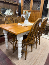 Load image into Gallery viewer, Crafted from solid pine, this chunky dining table combines rustic charm with practical durability. Structurally sound and well-maintained, it bears the gentle patina of everyday use—a few minor marks that add character rather than detract. Comfortably seats 4–6 guests, making it ideal for family meals and gatherings. Its warm, natural finish complements country, farmhouse, and traditional interiors beautifully.

Delivery Available

Overall Dimensions

137cm long x 76cm wide x 75cm high

