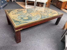 Load image into Gallery viewer, This charming coffee table showcases a brass-framed glass top featuring an antique-style world map beneath. While it has some light signs of use, these are minimal and add to its unique character. It’s sure to be a delightful conversation starter in any room.

Delivery Available

Overall Dimensions

129cm wide x 68cm deep x 36cm high

