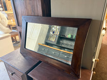Load image into Gallery viewer, This elegant hardwood mirror combines timeless design with solid construction. Crafted from quality hardwood, it brings warmth and light to any room. It has some marks but nothing too major. Perfect for hallways, bedrooms, or living spaces seeking a sophisticated focal point.

Delivery Available

Overall Dimensions

85cm wide x 51cm high

