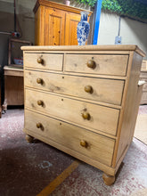 Load image into Gallery viewer, This exceptional antique pine chest of drawers combines timeless character with practical storage. Structurally sound and well-preserved, it features authentic dovetail jointed construction with two short drawers above three generous long drawers—ideal for bedroom or living room organisation. Minor patina marks add to its vintage charm, making it a striking focal point for period or eclectic interiors.

Delivery Available

Overall Dimensions

105cm wide x 46cm deep x 104cm high

