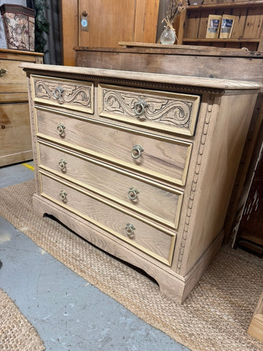 The beautiful Jaycee chest of drawers is crafted from oak and has been carefully stripped back to its natural, untainted state, showcasing the wood’s authentic grain and character. It features generous storage space with two shorter drawers on top and three longer drawers below, perfect for organising your belongings with ease. While the wood is currently untreated, a coat of wax can be applied to protect and enhance its finish, allowing you to customise its look and preserve its natural charm. This piece c