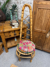 Load image into Gallery viewer, A dependable bamboo and rattan high-backed chair with genuine vintage appeal. The frame remains structurally intact and ready for everyday use, whilst light wear marks reflect its history. Overall condition is solid, making it a practical addition to any room. Supplied with cushion.

Delivery Available

Overall Dimensions

approx : 41cm wide x 41cm deep x 117cm high

