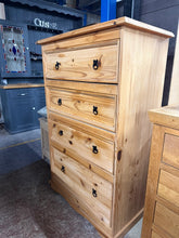 Load image into Gallery viewer, This sturdy tall pine drawer unit offers practical storage with four spacious drawers, perfect for bedrooms, living spaces, or home offices. Built to last, the pine construction remains structurally sound. As a pre-loved piece, it bears the gentle patina of use with minor surface marks but nothing major. An affordable, sustainable choice for those seeking quality furniture.

Delivery Available

Overall Dimensions

82cm wide x 48cm deep x 129cm high&nbsp;

