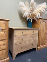Load image into Gallery viewer, A beautiful solid oak chest with three generous dovetail-jointed drawers, stripped back to reveal the natural grain. Good condition and structurally sound, it will benefit from a protective coat of wax to enhance and seal the wood. Minor surface marks consistent with vintage pieces. Ready to become a focal point in any bedroom or hallway.

Delivery Available

Overall Dimensions

91cm wide x 48cm deep x 79.5cm high

