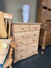 Load image into Gallery viewer, A charming solid pine chest of drawers, stripped back to reveal natural wood grain and character. Features two short dovetail-jointed drawers above four spacious long drawers, offering practical storage for any room. Structurally sound and in good condition. The natural finish may benefit from a protective coat of wax to enhance durability and appearance.

Delivery Available

Overall Dimensions

81cm wide x 43.5cm deep x 97cm high


