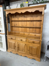 Load image into Gallery viewer, This solid pine dresser is both structurally sound and in excellent condition. It boasts abundant storage with 2 shelves and 3 top drawers, followed by 3 dovetail jointed drawers, and a double and single cupboard in the base section. Although previously used, it only has minor marks. For easier relocation, the top can be detached from the base.

Overall Dimensions

156cm wide x 43cm deep x 193.5cm high

DELIVERY AVAILABLE      

For our other items see our website https://fossewayfurniture.co.uk

collection
