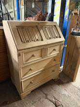 Load image into Gallery viewer, Discover the timeless appeal of this beautifully restored oak bureau, returned to its authentic natural finish. Three generously proportioned dovetail-jointed drawers provide substantial storage capacity, while the elegant pull-down writing desk offers both workspace and concealed storage. A light wax finish will enhance and protect the wood&#39;s character. Includes the original key, adding to its charm and functionality.

Overall Dimensions

76.5cm wide x 43cm deep x 100cm high

DELIVERY AVAILABLE      

For 

