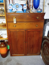 Load image into Gallery viewer, A striking mid-century drinks cabinet from the 1940s, built to last with authentic dovetail-jointed drawers and solid construction. Features two spacious drawers above a double cupboard with internal shelf—ideal for storing glassware, bottles, and bar essentials. Structurally sound with minor patina marks that add character. Perfect for period homes or vintage-inspired interiors seeking genuine period authenticity.

Delivery Available

Overall Dimensions

83.5cm wide x 46cm deep x 114.5cm high&nbsp;

