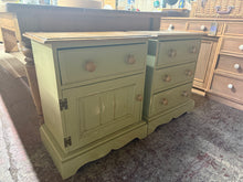 Load image into Gallery viewer, A charming pair of solid pine bedsides with character and potential. Both feature quality dovetail joinery—one with three drawers, the other with a drawer and cupboard combination. Currently finished in green paint with minor surface wear and scratches that add to their vintage appeal. Perfect for refinishing or upcycling projects, or as-is for a rustic aesthetic.

Delivery Available

Overall Dimensions

56cm wide x 35cm deep x 65cm high

