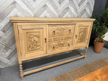 Load image into Gallery viewer, This exquisite oak sideboard has been fully restored to its original condition and may require a layer of wax for protection. The elegant drawer and door fronts showcase intricate carvings, while the piece is supported by stunning barley twist legs. It offers ample storage with 2 long dovetail jointed drawers and 2 cupboards.

Overall Dimensions

149.5cm wide x 45cm deep x 94cm high

DELIVERY AVAILABLE      

For our other items see our website https://fossewayfurniture.co.uk

collection from our shop at cv
