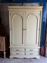 Load image into Gallery viewer, A charming French-style wardrobe with timeless appeal and practical storage. This preloved piece is structurally sound and in good condition, bearing light wear consistent with its history. It features one hanging rail for garments and four dovetail-jointed drawers for folded items, providing generous storage capacity. The wardrobe disassembles for convenient transport and repositioning, making it ideal for those who value both style and functionality in their bedroom furniture.

Delivery Available

Overall
