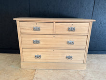 Load image into Gallery viewer, A beautiful satinwood chest of drawers, stripped back to reveal its natural grain and warm patina. Features two short dovetail-jointed drawers above two generous long drawers, offering substantial storage space. Structurally sound and in good condition. The bare wood finish showcases the quality craftsmanship and may benefit from a protective coat of wax to enhance and preserve the satinwood's natural beauty.

Delivery Available

Overall Dimensions

107cm wide x 47cm deep x 79cm high
