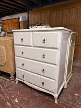 Load image into Gallery viewer, Elevate your bedroom or hallway with this charming French-style chest of drawers. Featuring a timeless design, it combines practical storage with elegant aesthetics. The layout includes two compact upper drawers and three generous lower drawers—perfect for organising clothing, linens, or decorative items. Structurally sound and well-maintained, this preloved piece carries gentle wear that adds authentic character. An understated yet striking focal point for any interior.

Delivery Available

Overall Dimensi
