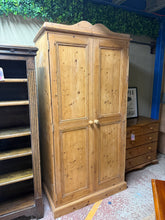 Load image into Gallery viewer, A sturdy solid pine wardrobe in good working condition. This pre-loved piece features two internal hanging rails, perfect for organising your wardrobe. Light surface marks reflect its honest vintage character. Structurally sound and ready to serve you well.

Delivery Available

Overall Dimensions

100cm wide x 54cm deep x 199cm high&nbsp;

