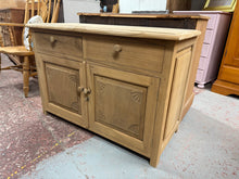 Load image into Gallery viewer, Discover the raw beauty of this exceptional hardwood sideboard, restored to reveal its authentic character and grain. With two elegantly crafted dovetail drawers positioned above a spacious double cupboard, it offers generous storage while celebrating the wood's natural finish. A protective wax coating will enhance its lustre and durability, making it a timeless addition to any room.

Overall Dimensions

110cm wide x 50cm deep x 76cm high

DELIVERY AVAILABLE      

For our other items see our website https:
