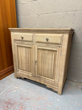Load image into Gallery viewer, This beautiful stripped oak sideboard is solidly built and generally well maintained. Fully stripped to reveal its natural finish, it would look great with a layer of wax to protect the surface. It offers plenty of storage space, featuring two short dovetail-jointed drawers above a double cupboard with a single shelf inside.

Overall Dimensions

95cm wide x 46.5cm deep x 92cm high

DELIVERY AVAILABLE      

For our other items see our website https://fossewayfurniture.co.uk

collection from our shop at cv36
