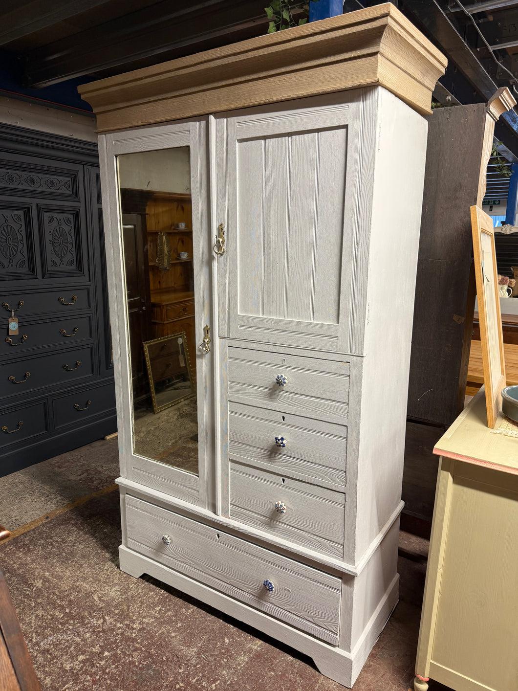 This beautiful oak wardrobe features a fresh white paint finish. While it shows some signs of previous use, a little touch-up will easily restore its charm. Offering plenty of storage space, it includes three small dovetail-jointed drawers, one large drawer, a long cupboard with several hanging hooks, and a smaller cupboard with a shelf. For convenience, it can be taken apart into three sections to make moving simpler.

Overall Dimensions

117cm wide x 54cm deep x 202cm high

DELIVERY AVAILABLE      

For o
