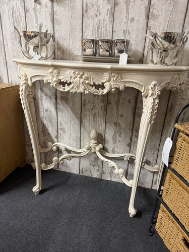 This beautiful French style console table is sturdy and well-preserved. It shows some signs of use, but only minor marks that don’t take away from its charm. The intricate carved details will bring a lovely sense of sophistication to any space.

Delivery Available

Overall Dimensions

101cm wide x 39cm deep x 83cm high  
