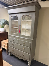Load image into Gallery viewer, A well-constructed display cabinet in good working order, featuring two shelves in the upper section above two short and two long dovetail-jointed drawers. The finish shows age-appropriate wear with minor chips throughout, though structurally sound. Splits into two sections for convenient transport and includes the original key. Ideal for displaying collections or storing items with style.

Delivery Available

Overall Dimensions

126cm wide x 57cm deep x 210cm high&nbsp;&nbsp;

