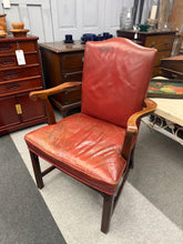 Load image into Gallery viewer, A timeless Georgian Gainsborough armchair upholstered in rich red leather. This structurally sound piece brings classic elegance to any office or living room. The leather retains its character with a patina that deepens its charm—a light polish will restore its lustre. An ideal statement accent piece for those who appreciate period furniture with authentic presence.

Delivery Available

Overall Dimensions

approx : 65cm wide x 54cm deep x 97.5cm high

