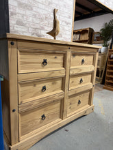 Load image into Gallery viewer, A spacious pine chest offering six generous drawers for ample storage. Stripped to natural wood, this piece showcases authentic grain and character. Consider applying wax finish to enhance protection and depth. Ideal for bedrooms, living spaces, or hallways seeking timeless functionality and rustic appeal.

Delivery Available

Overall Dimensions

132cm wide x 48cm deep x 104.5cm high


