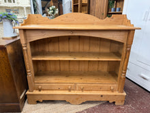 Load image into Gallery viewer, A delightful piece of vintage charm, this pine bookcase combines timeless appeal with practical storage. Solidly constructed and well-preserved, it features a single shelf perfect for displaying treasured items, plus two beautifully crafted dovetail-jointed drawers for tucking away essentials. Minor surface marks only add to its authentic character and would polish away beautifully to reveal the wood&#39;s natural warmth.

Overall Dimensions

122cm wide x 37.5cm deep x 109cm high

DELIVERY AVAILABLE      

For 
