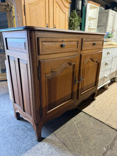This elegant oak sideboard is in excellent structural condition and overall good shape. Although it is pre-owned and may have a few marks, they are minor and do not detract from its beauty. The sideboard features two dovetail jointed drawers on top of a double cupboard with one internal shelf. It also includes two keys for added convenience.

Overall Dimensions

114cm wide x 49cm deep x 95cm high

DELIVERY AVAILABLE      

HAVE THIS PAINTED A COLOUR OF YOUR CHOICE FOR AN EXTRA £80 OR HAVE IT COMPLETELY STRI