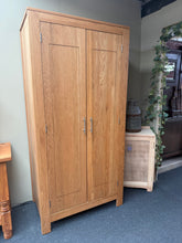 Load image into Gallery viewer, This solid oak wardrobe combines practical storage with timeless appeal. Structurally sound and in good overall condition, it features a generous hanging rail and shelf space inside—ideal for organising clothes and accessories. Light surface marks add character to this well-loved piece, perfect for those seeking solid furniture with genuine charm and functionality.

Delivery Available

Overall Dimensions

90cm wide x 55cm deep x 185.5cm high

