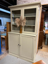 Load image into Gallery viewer, Charming sage green dresser with vintage character and generous storage. Features shelving on top and cubby holes in the base, perfect for displaying treasures or storing essentials. Hand-painted finish shows its pre-loved history with decoupage details inside—adding authentic charm and uniqueness. Separates into two pieces for convenient transport and room placement. Ideal for those who appreciate character-filled, sustainable furniture with practical everyday function.

Delivery Available

Overall Dimensi
