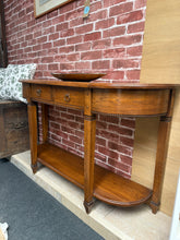 Load image into Gallery viewer, A timeless oak console table combining classic design with practical storage. Structurally sound with minor patina marks that add character. Features a lower shelf, two drawers, and two concealed cupboards—ideal for organising hallway essentials while maintaining a clean aesthetic. Versatile enough for entryways, living rooms, or behind sofas.

Delivery Available

Overall Dimensions

119cm wide x 33.5cm deep x 73cm high

