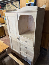Load image into Gallery viewer, A charming solid pine children's wardrobe built to last. Structurally sound with good overall condition, this piece features a single cupboard with hanging rail and four dovetail-jointed drawers for ample storage. The whitewashed finish shows character and patina; light restoration in areas would refresh its appearance. Ideal for adding vintage charm to a child's bedroom.

Delivery Available

Overall Dimensions

101cm wide x 54cm deep x 148cm / 162cm high&nbsp;&nbsp;


