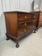 Load image into Gallery viewer, This elegant Edwardian-style mahogany chest of drawers combines timeless design with practical storage. Structurally sound and in good condition, it features two short drawers positioned above two generous long drawers—ideal for bedroom or hallway organisation. The piece bears the gentle patina of age with light surface marks that add character rather than detract from its appeal. A versatile addition to period properties or any home seeking vintage charm and authentic craftsmanship.

Delivery Available

Ov
