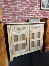 Load image into Gallery viewer, This beautiful stripped oak sideboard showcases the wood's natural grain and character.&nbsp; Two spacious drawers sit above a double cupboard featuring an internal shelf, offering plenty of room for dining essentials or living room organisation. The top displays gentle patina marks that add to its charm and authenticity. Structurally sound and ready to enhance any home.

Delivery Available

Overall Dimensions

91cm wide x 41cm deep x 81cm high

